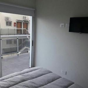 En eller flere senge i et værelse på Depto frente al mar San Bernardo + 12 billeder