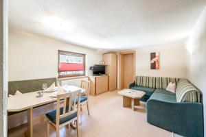a living room with a couch and a table at Pension Granbichler in Längenfeld