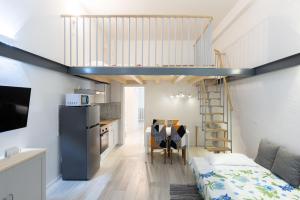 a room with a loft bed and a dining room at Andreini, Bologna by Short Holidays in Bologna
