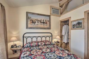 a bedroom with a bed and a painting on the wall at Kerrville Converted Barn Tiny Home with Kayaks! in Kerrville