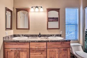 a bathroom with two sinks and two mirrors at 5 Mi to Big Bear Lake Cozy Cottage with Hot Tub in Big Bear City +26 photos