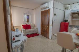 a living room with a couch and a red refrigerator at Maison Sophie in Chioggia