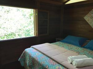 En eller flere senger på et rom på Reserva dos Manacás