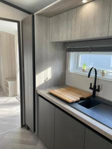 a kitchen with a sink and a counter top at Falconers Lodge with Hot Tub in Barmby on the Moor