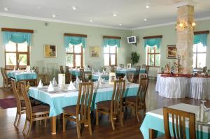 a dining room with blue tables and chairs at Monark Hotel Cappadocia in Nevşehir
