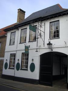 a white building with a large doorway in front of it at Crown Hotel in Downham Market