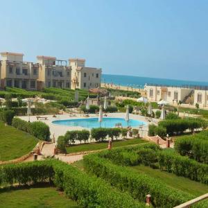 a view of a resort with a swimming pool at La Perla Resort Ras Sudr in Ras Sedr