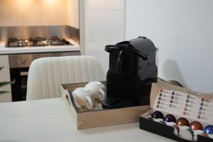 a black appliance sitting on a table next to a box at Maison Sophie in Chioggia +16 photos