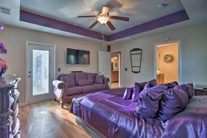 a bedroom with a purple bed and a ceiling fan at Screened Patio Rincon Home, 18 Mi to Savannah! in Rincon
