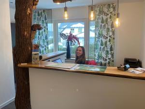 a woman sitting at a counter in a room at Astrid's Pension in Winterberg