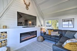 een woonkamer met een bank en een open haard bij Puget Sound Cabin with Hot Tub and Water Views! in Bremerton
