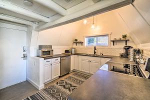 a large kitchen with white cabinets and a sink at Puget Sound Cabin with Hot Tub and Water Views! in Bremerton +22 photos