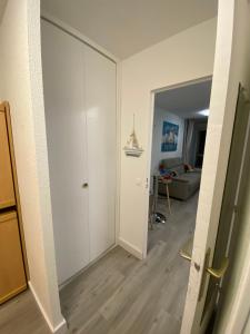 a room with a sliding door and a living room at Studio front de mer 'Le Soleillan' in La Grande Motte