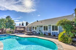a swimming pool in front of a house at Deluxe Laguna Hills Home with Outdoor Oasis! in Laguna Hills