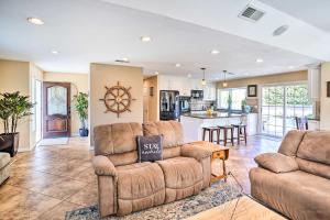 a living room with two couches and a kitchen at Deluxe Laguna Hills Home with Outdoor Oasis! in Laguna Hills