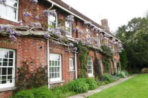 a brick house with flowers on the side of it at Bridge Farmhouse in Salisbury