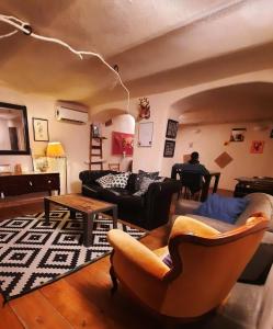 a living room with a couch and a table at Abbey Hostel in Genoa