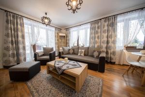 a living room with a couch and a table at Apartamenty Małgorzatka in Zakopane