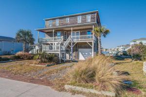 a large house with palm trees in front of it at Miramar in Holden Beach