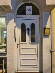 a white door with a sign on top of it at Stars Aspava Blue HOSTEL in Podgorica