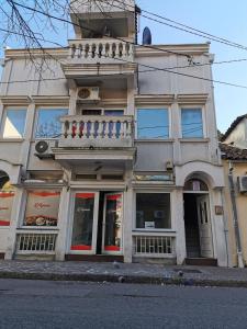 a building on the corner of a street at Stars Aspava Blue HOSTEL in Podgorica