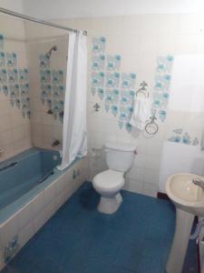 a bathroom with a toilet and a tub and a sink at Hotel Spring in Guatemala