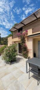 a patio with a table in front of a house at Villa Olivea in Rayol-Canadel-sur-Mer