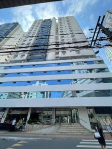 a tall white building with stairs in front of it at Apartamento com 3 dormitórios in Balneário Camboriú