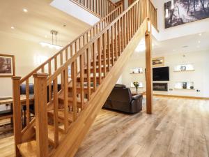 a wooden staircase in a home with a living room at 1 The Coach House in Elgin