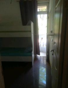 a room with a bed and a window and a door at Stars Aspava Blue HOSTEL in Podgorica