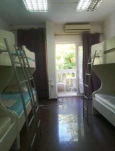 a room with three bunk beds and a window at Stars Aspava Blue HOSTEL in Podgorica