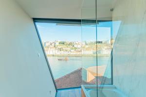 a view of the water from a room with a window at LUXURY VIEWS by YoursPorto in Vila Nova de Gaia