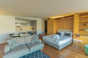 a living room with a bed and a couch at LUXURY VIEWS by YoursPorto in Vila Nova de Gaia