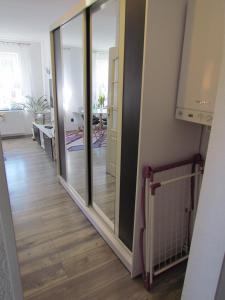 a hallway with sliding glass doors in a room at Apartament Ella in Polanica-Zdrój