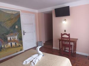 a room with a white animal laying on the bed at RIXAA Hotels in La Paz