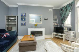 a living room with a couch and a fireplace at Sea View - Balcony - Free Parking in Ramsgate