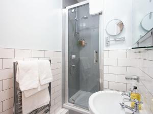 a bathroom with a shower and a sink at The Castleton in Swanage