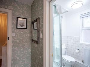 a bathroom with a toilet and a window at The Castleton in Swanage