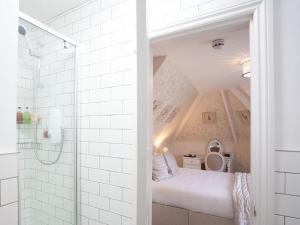 a attic bathroom with a bed in a room at The Castleton in Swanage
