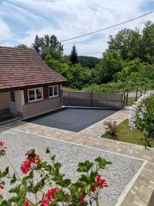 a backyard of a house with a fence and flowers at Holiday Home Deer Grove in Generalski Stol