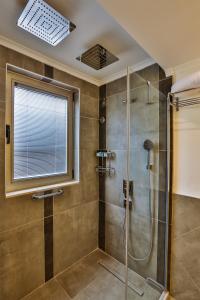 a bathroom with a shower with a glass door at Arnna Hotel in Kas