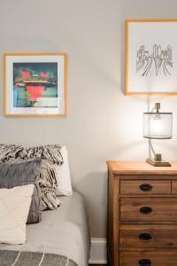 a bedroom with a bed and a dresser with a lamp at Rare 2 Bed 2 Bath Downtown Condo Near Aquarium in Atlanta