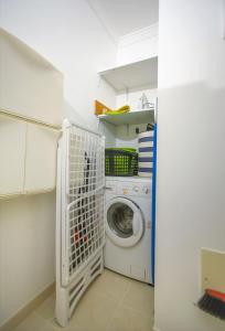 a laundry room with a washer and dryer at ALFELI-AP in Olhos de Água