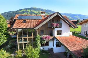 a house with solar panels on the roof at Appartement Paratscher in Westendorf