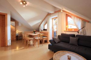 a living room with a couch and a table at Appartement Paratscher in Westendorf