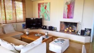 a living room with a couch and a fireplace at Stavento Apartments in Argostoli