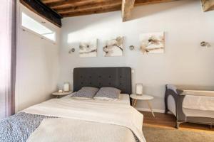 a bedroom with a large bed and two tables at Au coeur de la vieille ville in Annecy