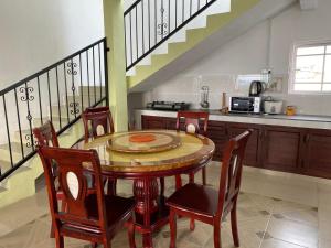 a kitchen with a table and chairs and a staircase at Green Discovery B&B Tamarind Falls 7 Cascades in Henrietta