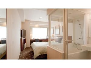 a hotel room with a bed and a bath tub at Boston Plaza Kusatsu Biwa Lake - Vacation STAY 15410v in Kusatsu