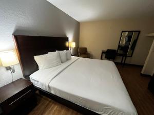 a large white bed in a hotel room at Motel 6 San Antonio, TX I-35 North Corridor in San Antonio